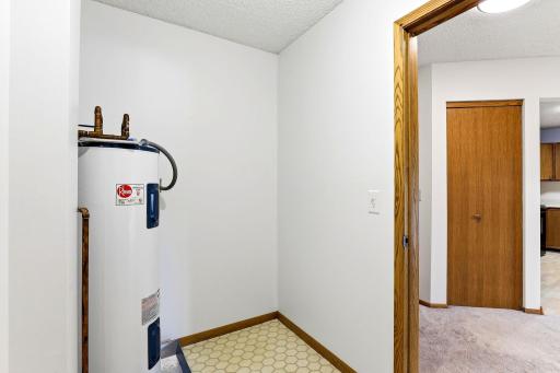 Welcoming foyer and plentiful storage in utility room, the entryway coat closet, AND additional private storage room just down the hall!