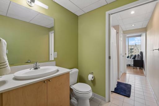 Walk through full bathroom with tub/shower combo & storage closet