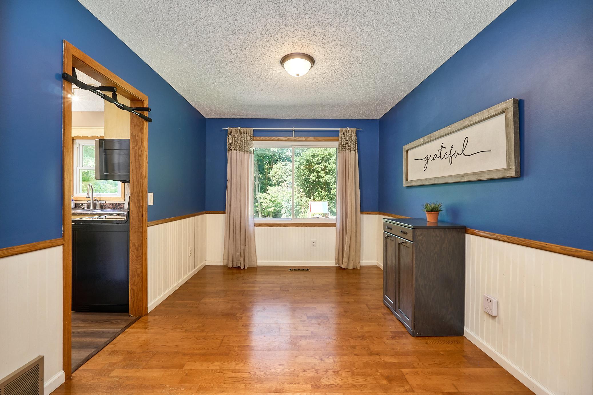 Formal dining room overlooks the park-like backyard.