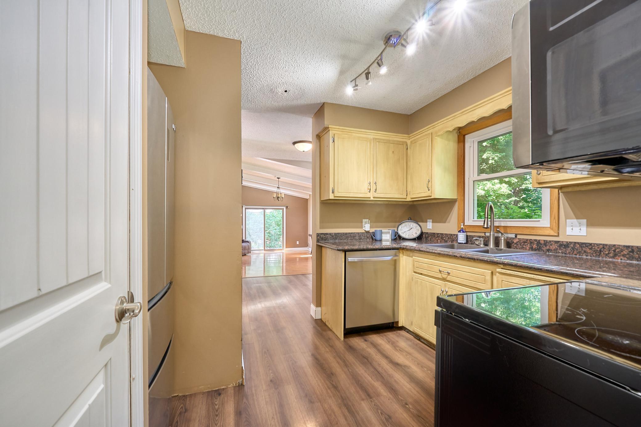 Kitchen is centrally located and overlooks the wood deck in the backyard.
