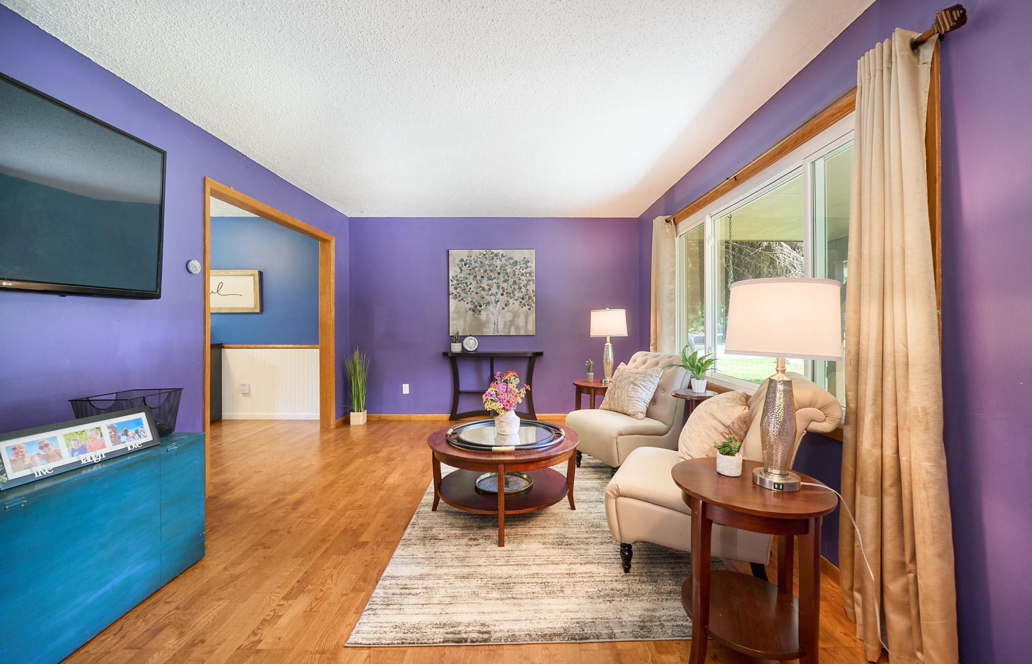 Step into the living room from the beautiful entryway. Enjoy the natural light throughout this home.