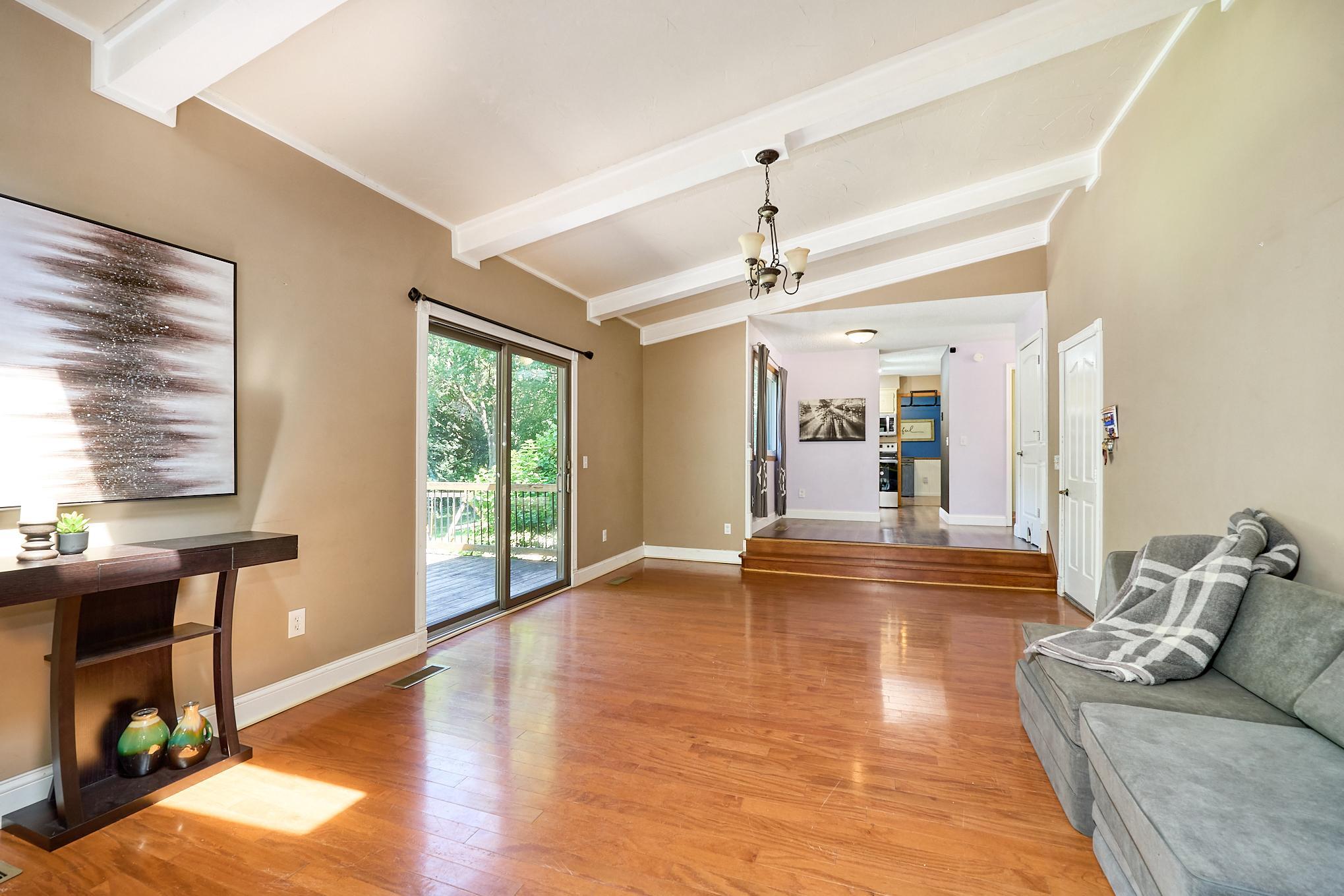 The vaulted family room opens to the dining area and kitchen, which walk out to the park-like backyard.