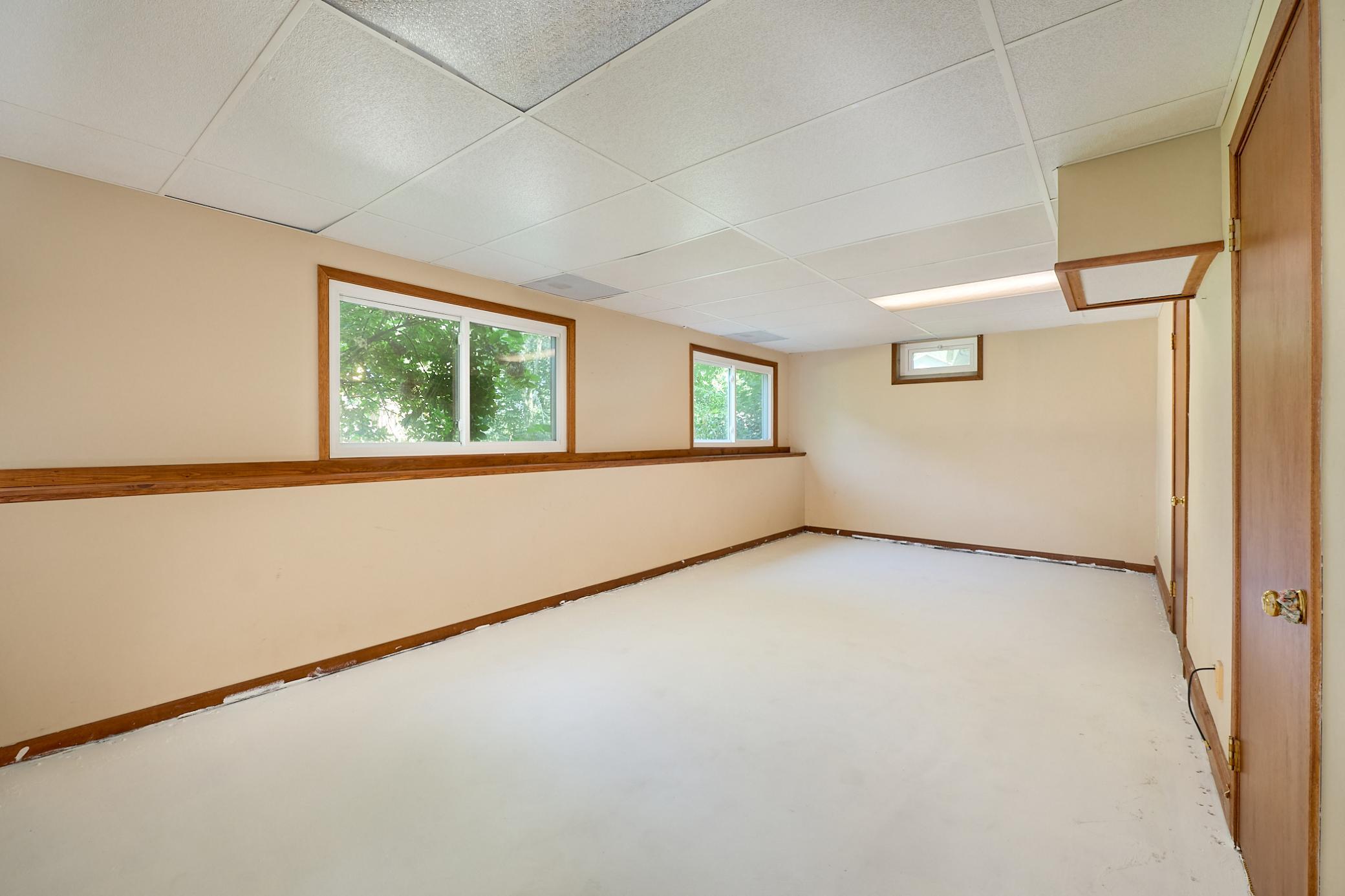 Lower-level family room is filled with light from the new windows that overlook the back yard