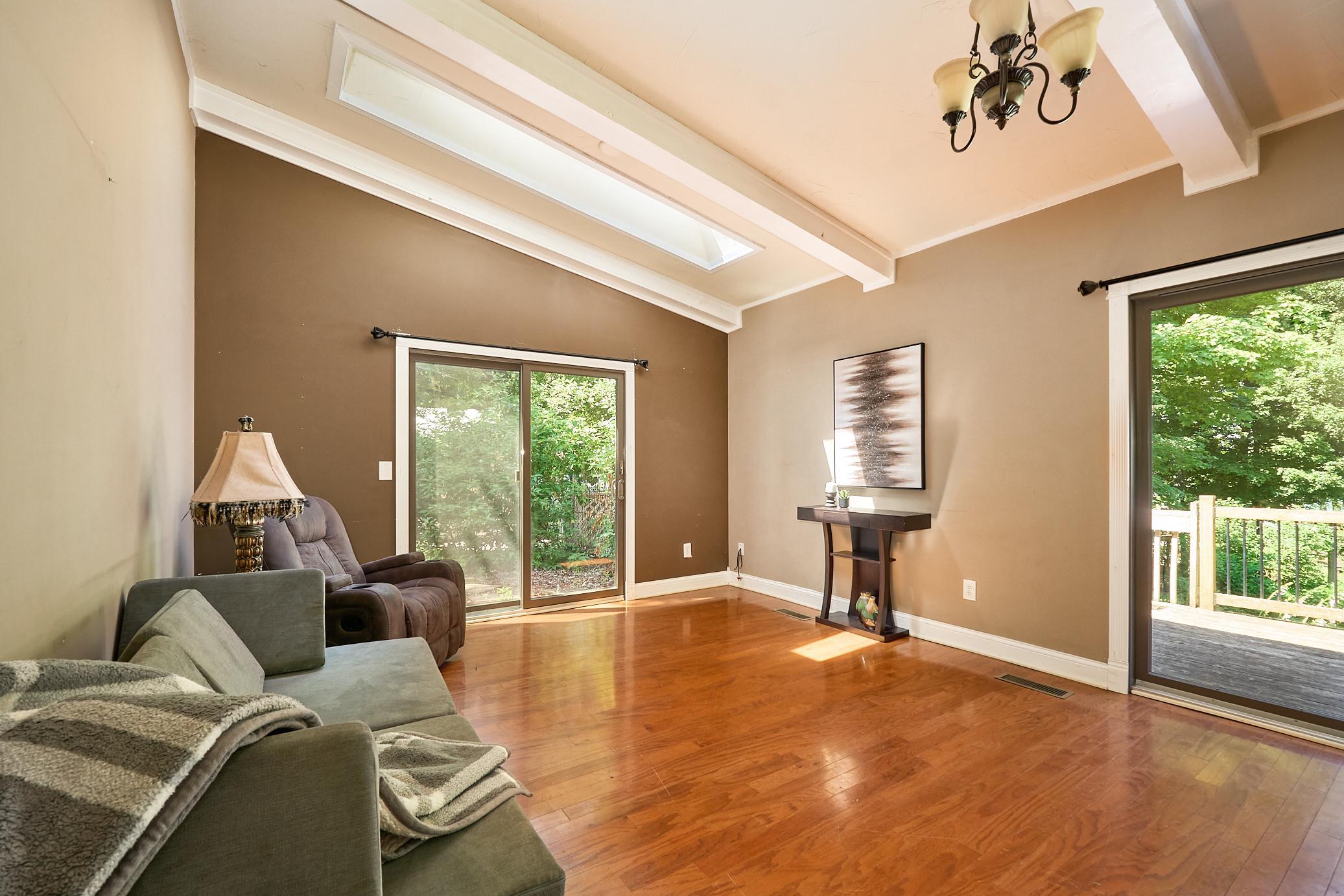 The vaulted family room is flooded with natural light from two patio sliders and a skylight.