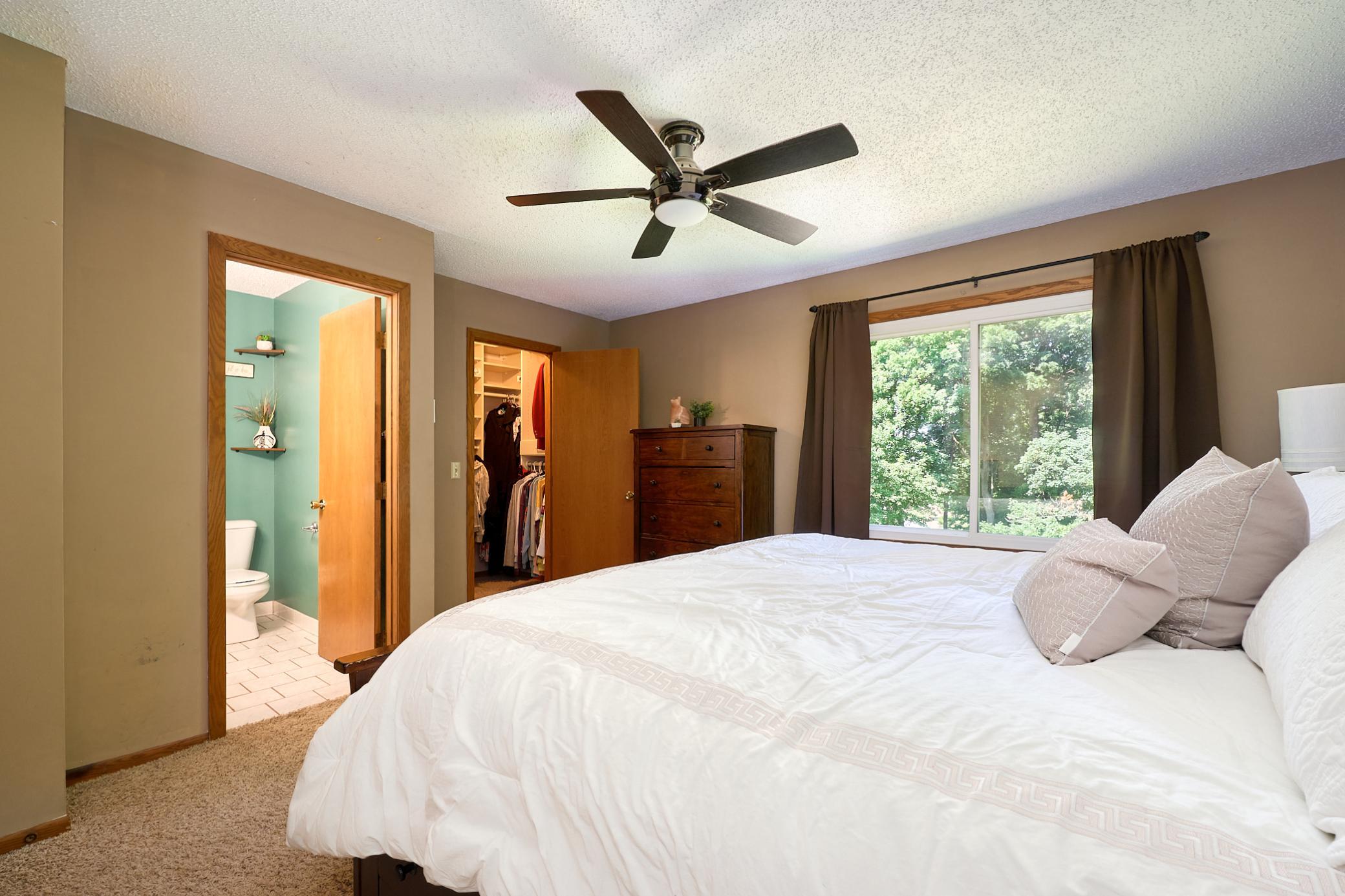 Spacious upper-level primary suite overlooks the park-like backyard and opens to the walk-in closet and private bathroom