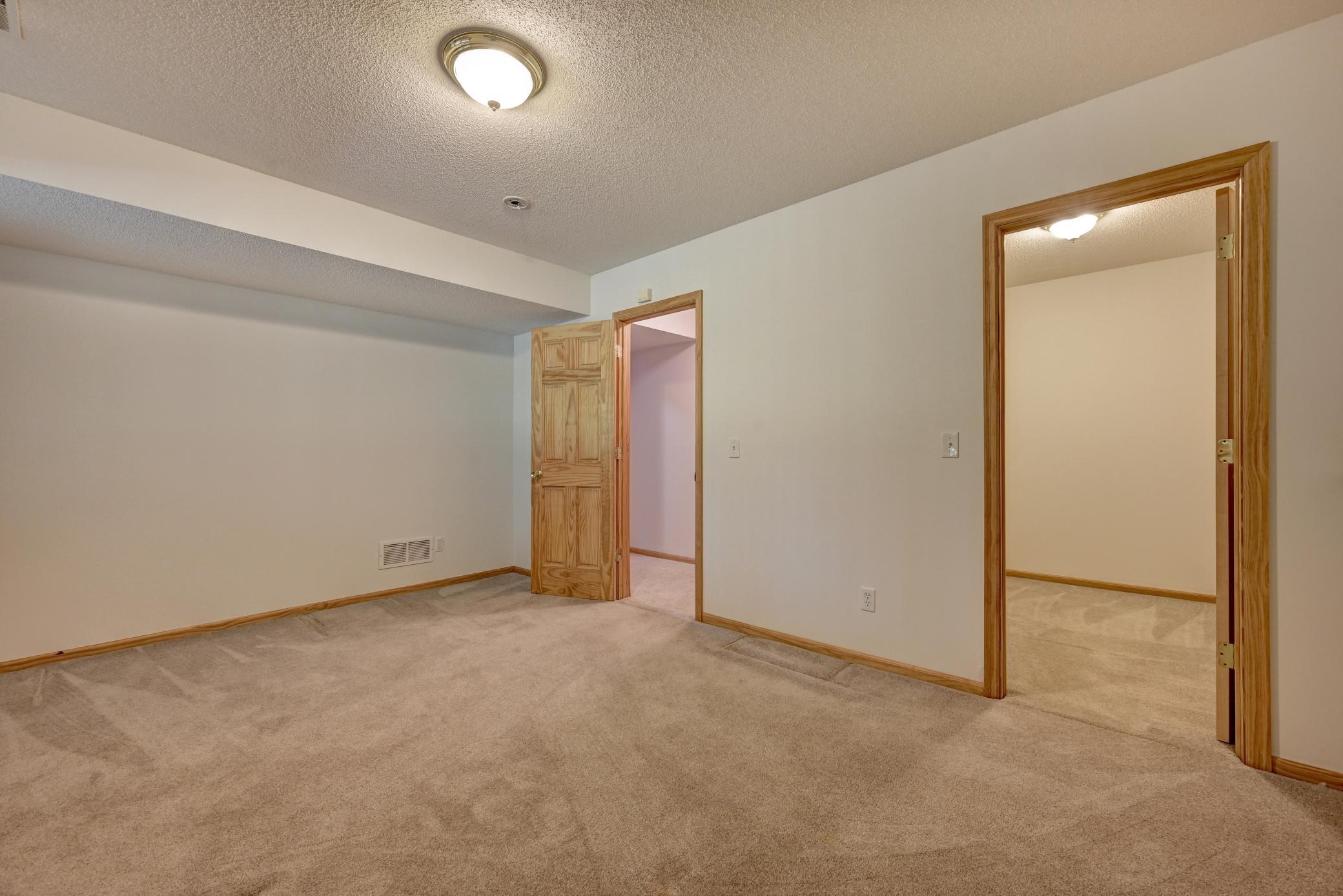 Basement bedroom with view of closet