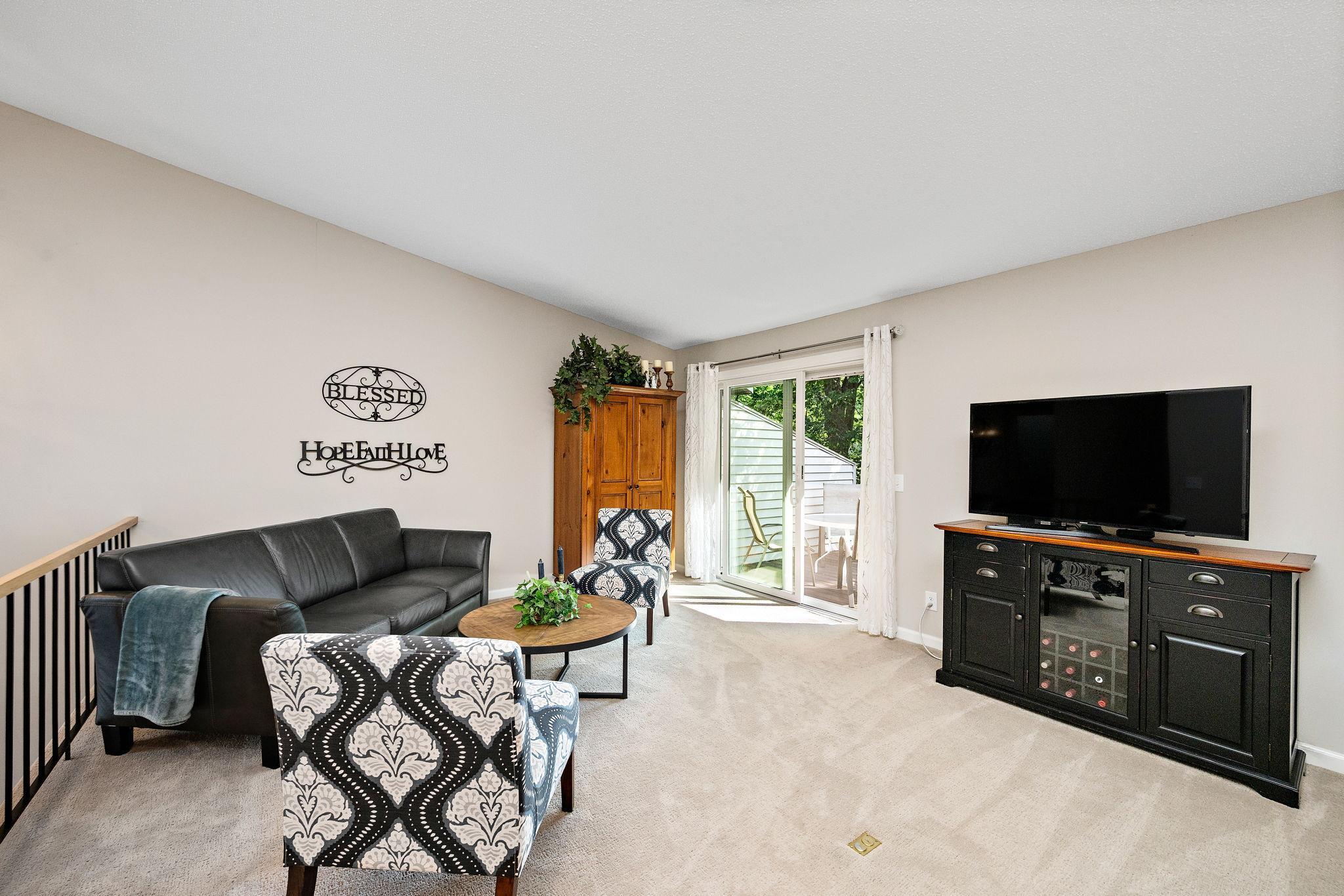 Step out to private deck overlooking green space