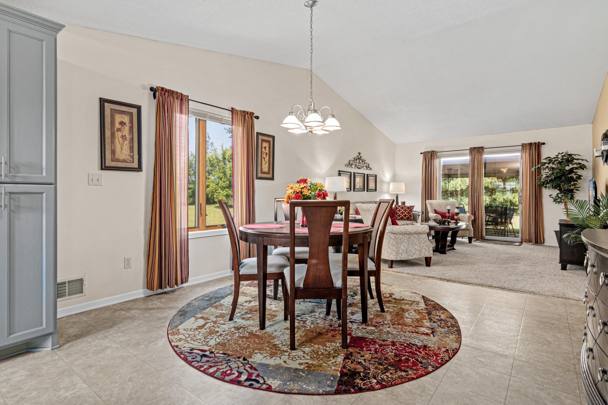 The dining area sits comfortably between the kitchen and living spaces
