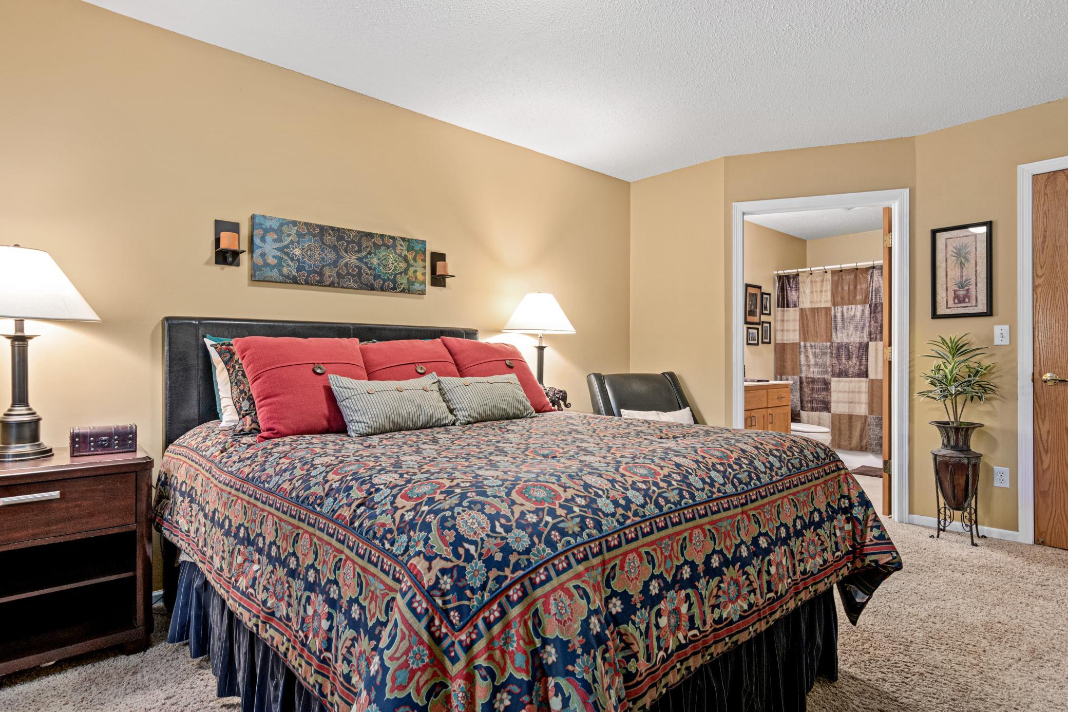 The spacious primary suite provides room to unwind with its own private full bath