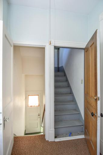 Stairs to separate exterior entrance to 2nd Level and Stairs up to Unfinished Attic
