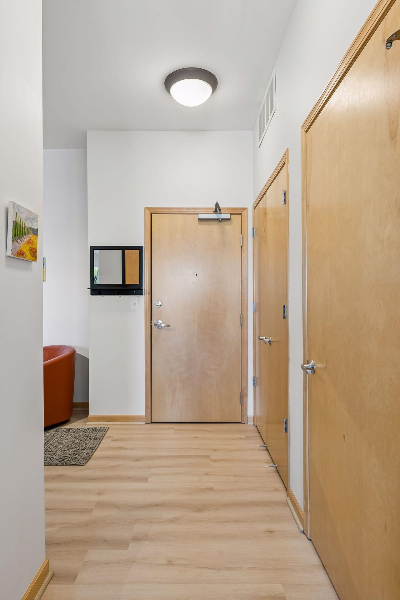 The middle door is a large double closet and the near one is the half bath.