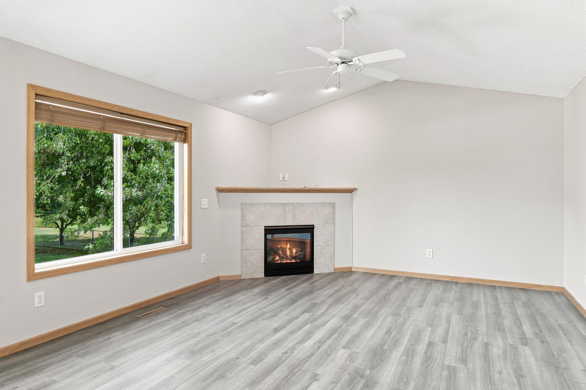 Main level living room with gas fireplace.