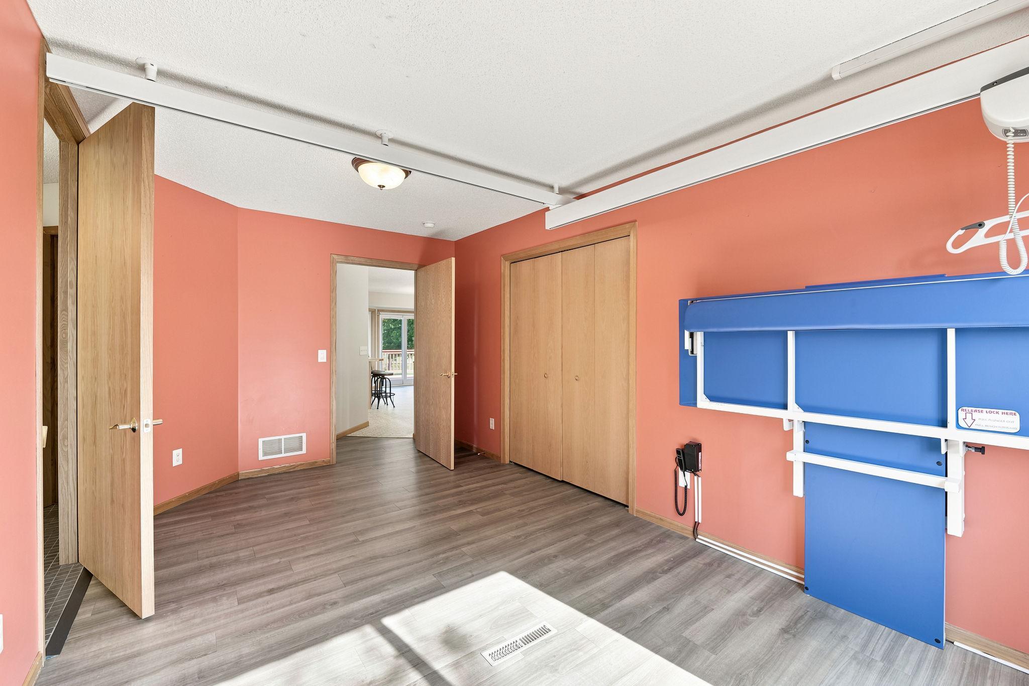 Main level bedroom with lift system and direct access to bathroom with walk-in shower.