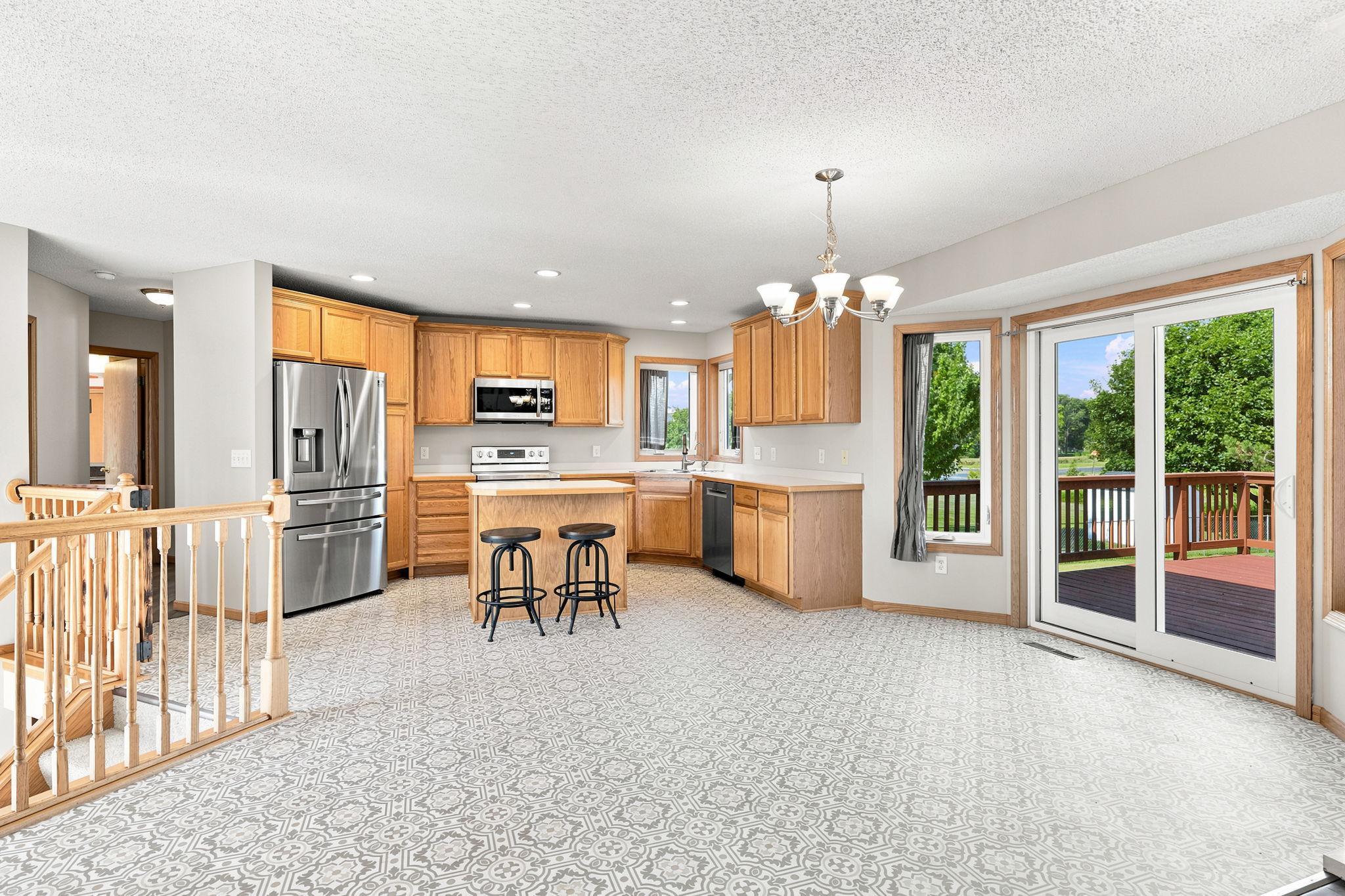 Spacious kitchen with center island and stainless steel appliances.