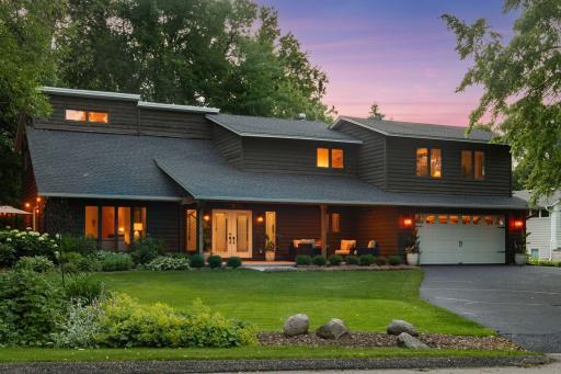 The home sits tucked beneath mature shade trees on a beautifully landscaped .35-acre lot.