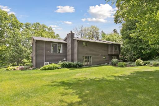 A private, tree-lined backyard offers a peaceful escape just steps from the patio.