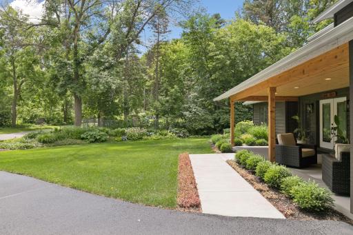 Mature trees and thoughtfully landscaped gardens surround the home.