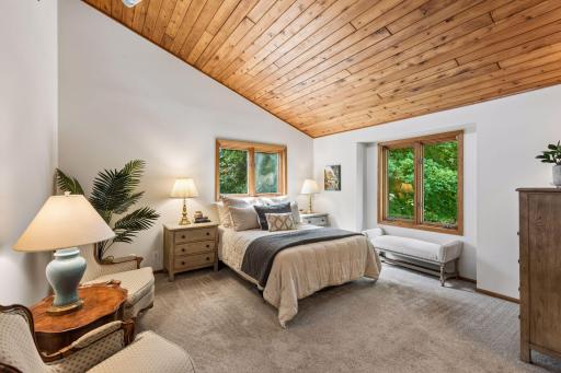 Spacious Primary suite with vaulted, wood-planked ceiling.