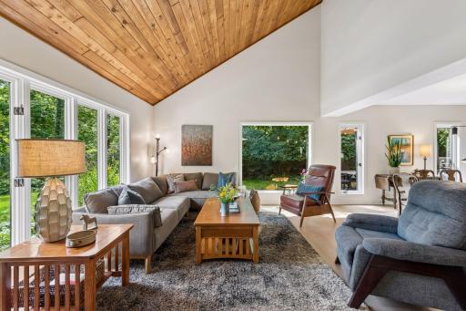 Vaulted ceilings and a wall of windows make the living room the heart of the main level.