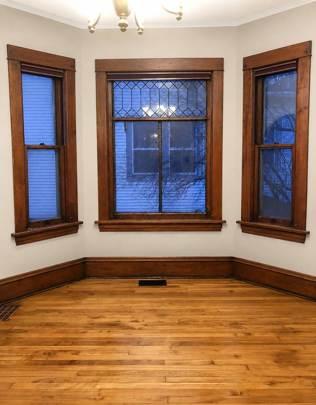 Sun filled dining room with 3 sided alcove- original leaded glass transome windows