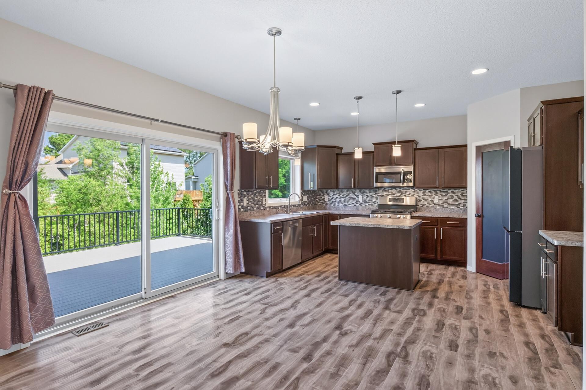 Main level kitchen, dining area, and access to deck