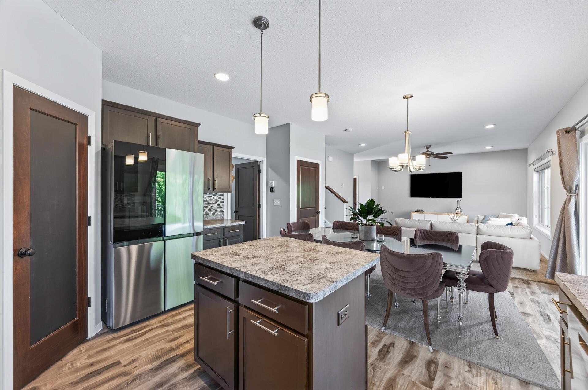 Main level kitchen, dining area and living room - virtually staged