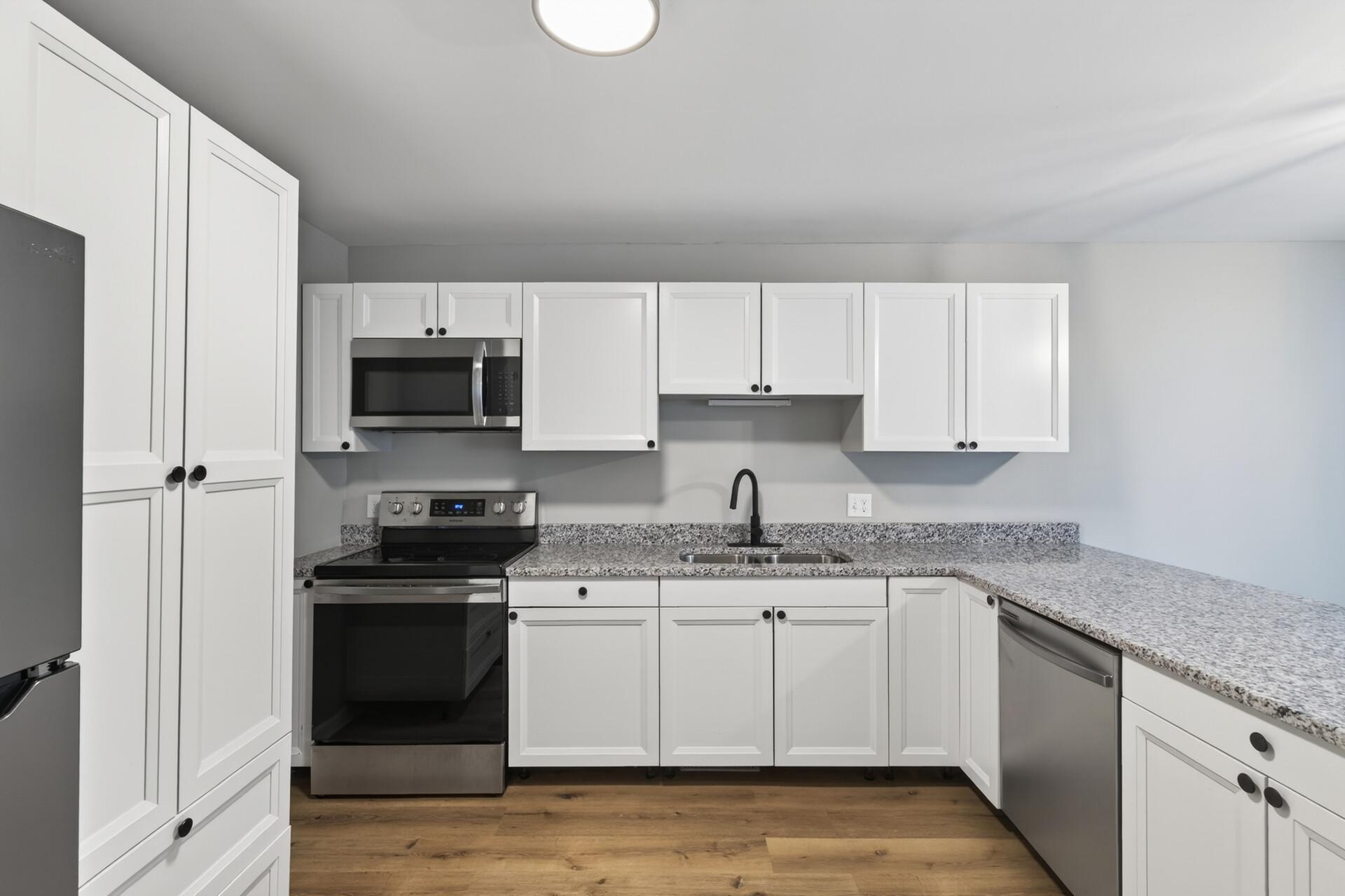 Stylish kitchen with stainless steel appliances, updated cabinetry, and generous prep space.