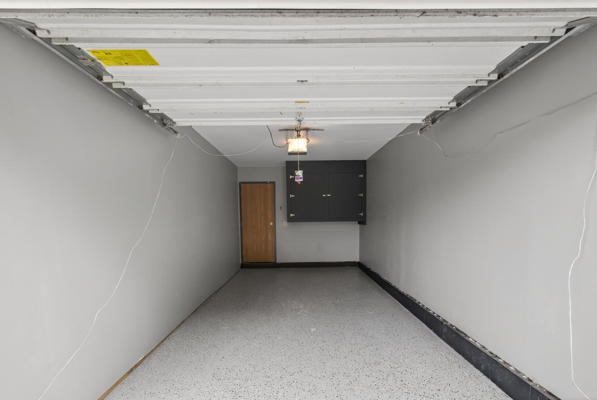 Updated one-car garage with epoxy flooring and professionally painted walls and ceiling.