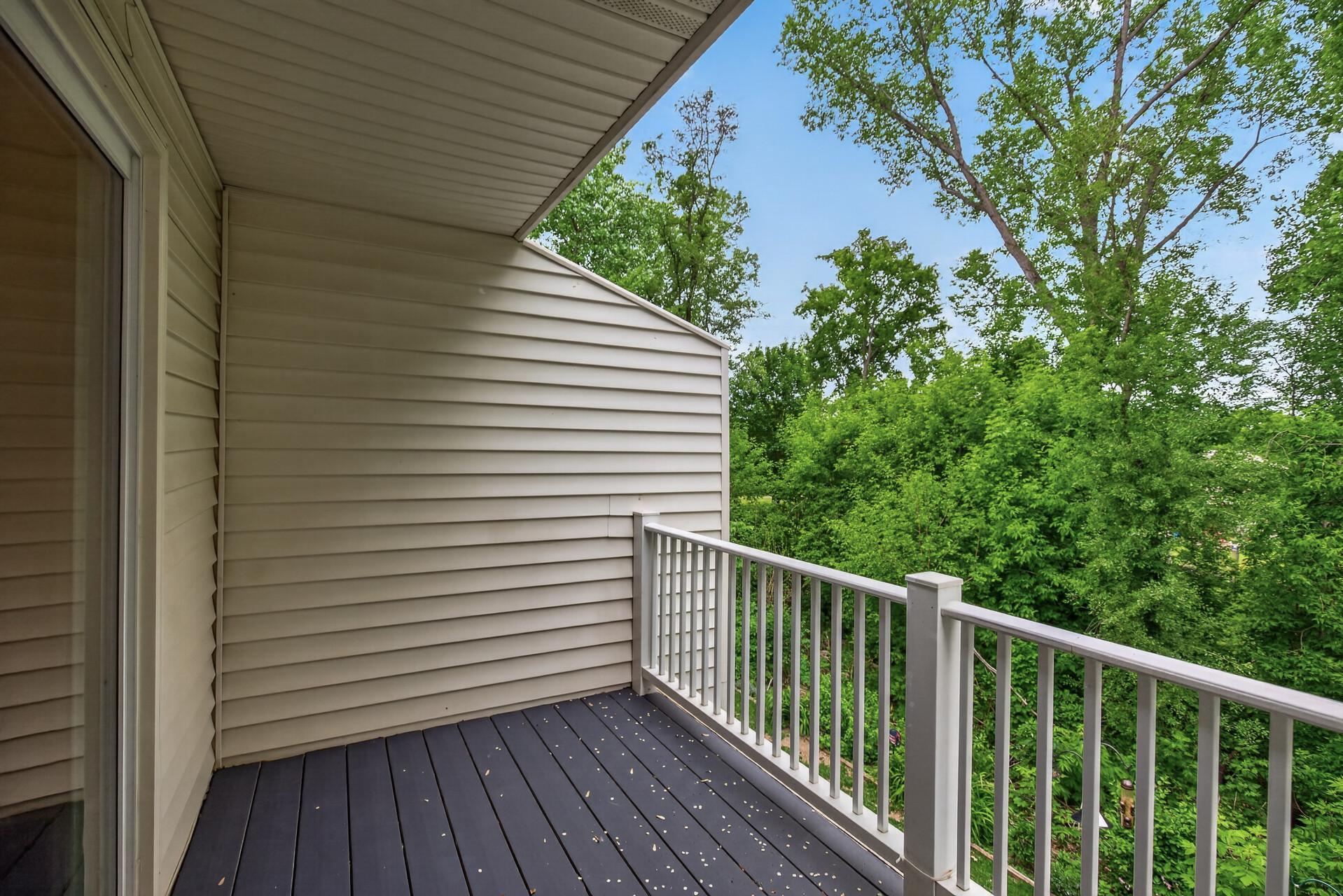 Private deck overlooking mature trees and wooded views.