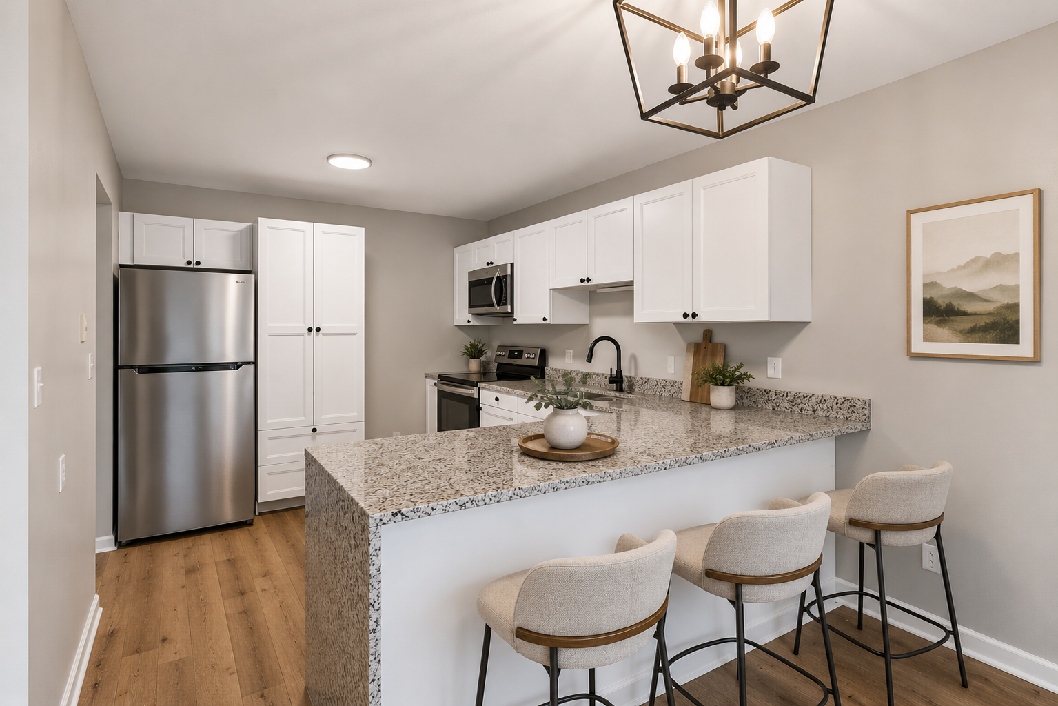 Completely renovated kitchen with granite waterfall countertops, breakfast bar seating, stainless steel appliances, and new cabinetry. (Virtually staged)