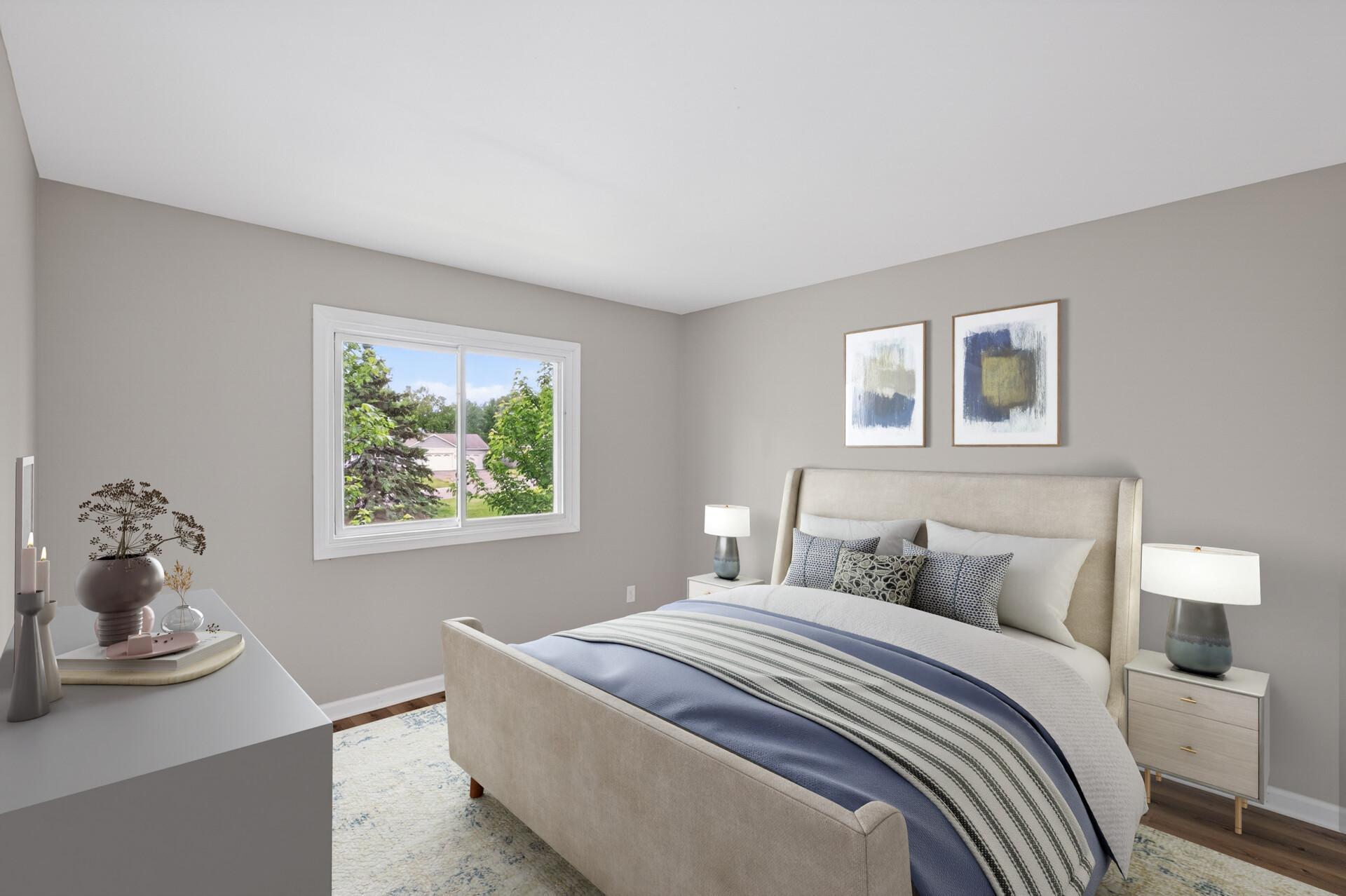 Spacious secondary bedroom with a large window and updated finishes throughout. (Virtually staged)