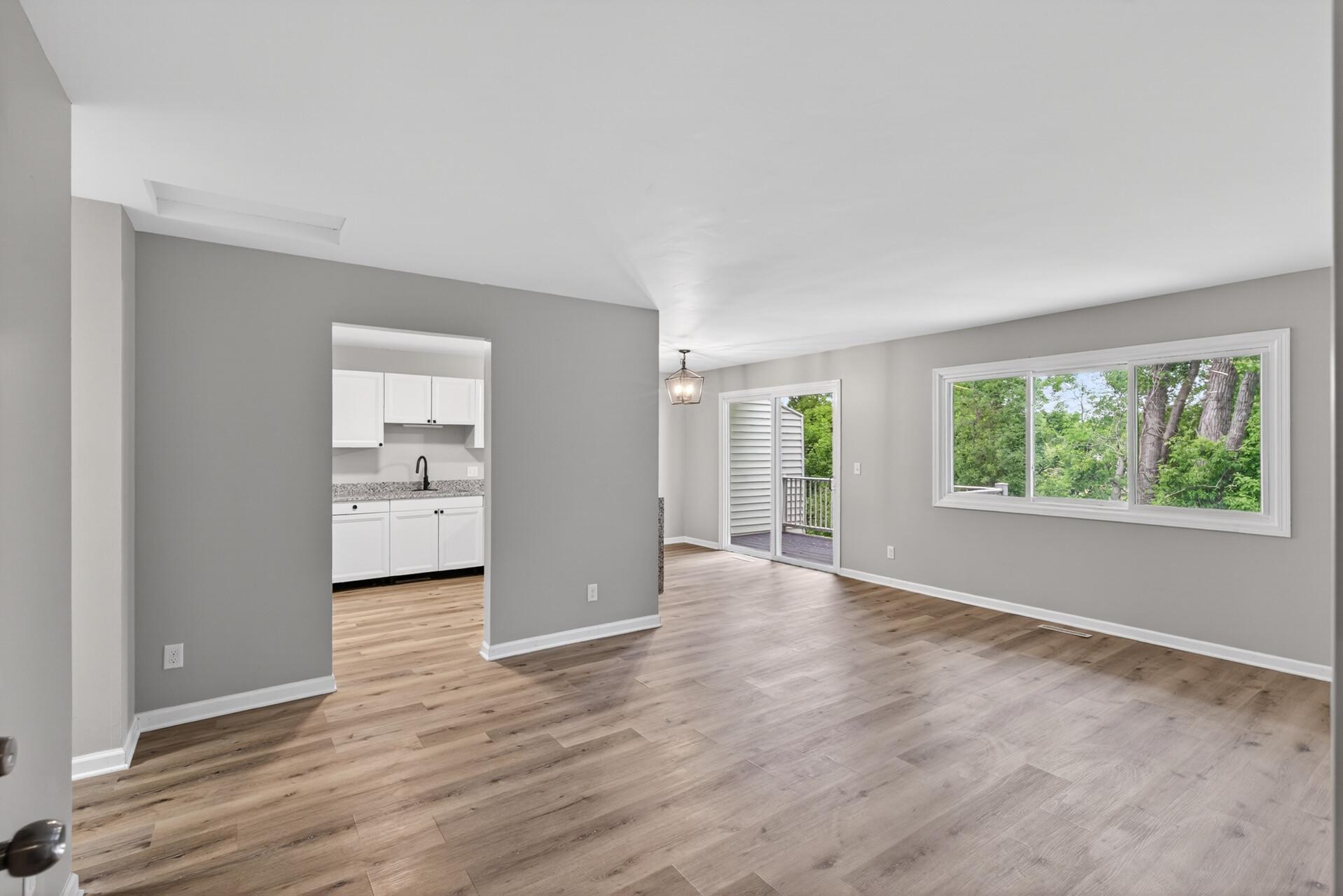 Spacious open-concept living area with updated flooring and abundant natural light.