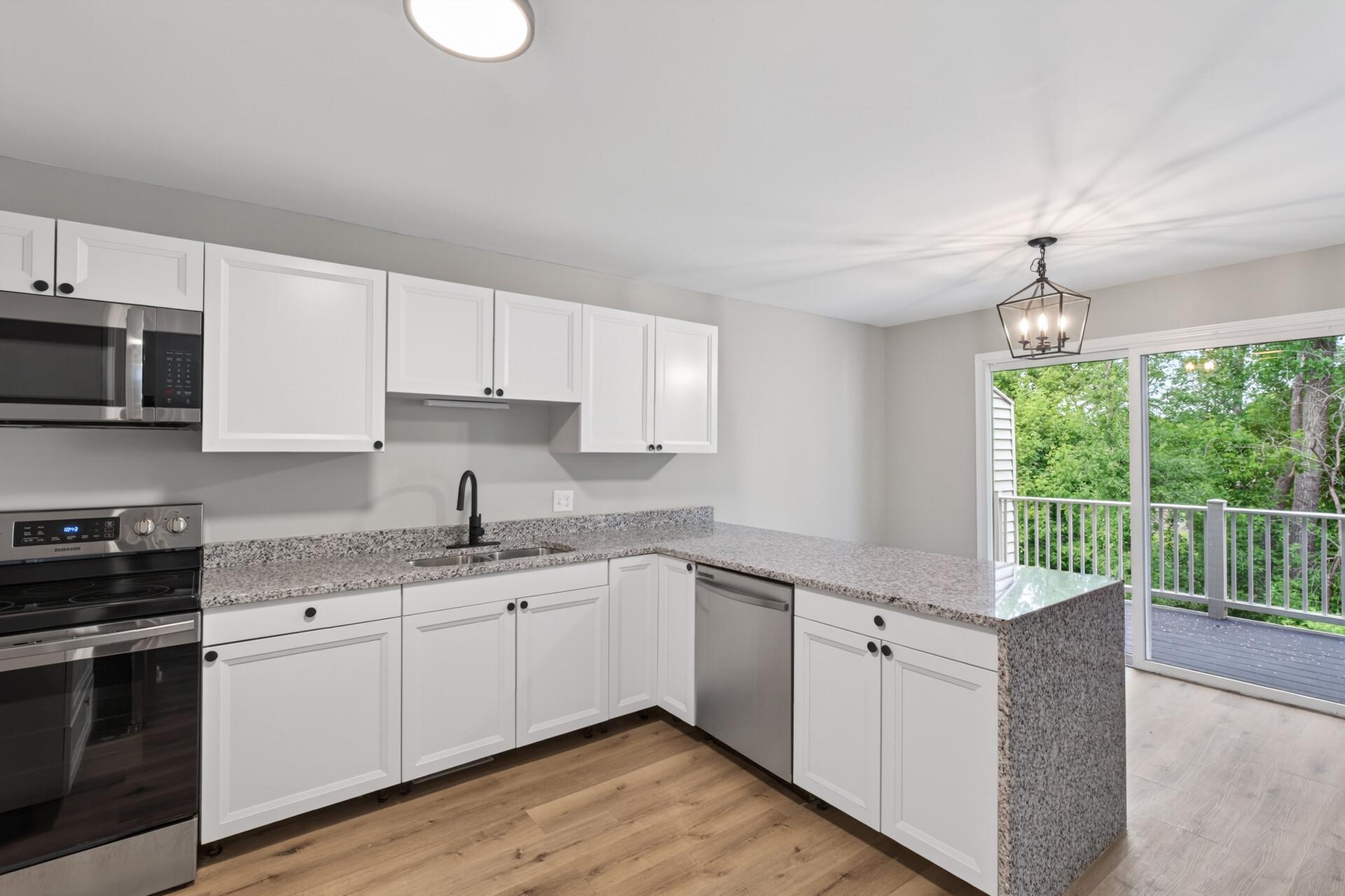Bright kitchen with abundant cabinet space, updated hardware, and modern finishes.