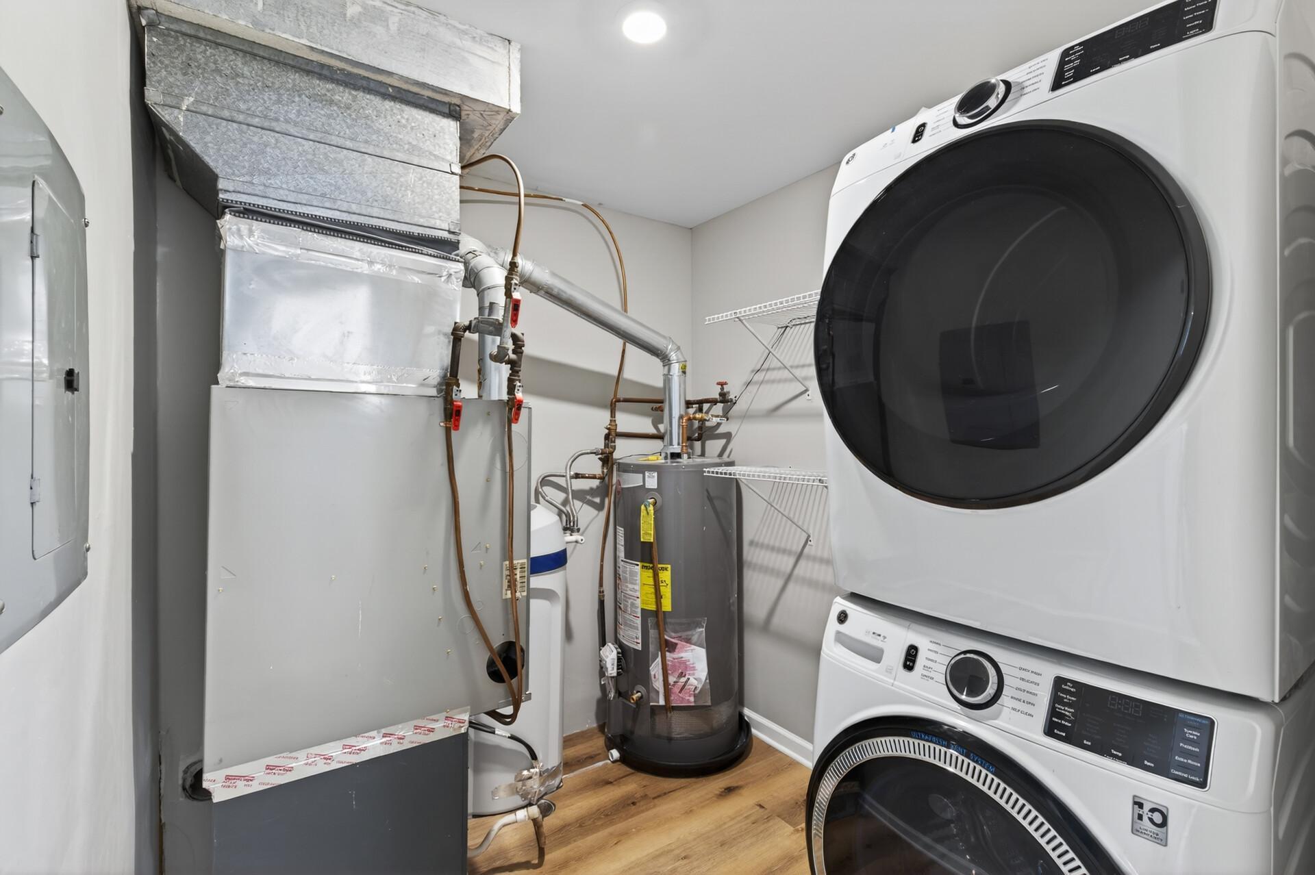 Laundry area featuring a brand new stackable washer and dryer.
