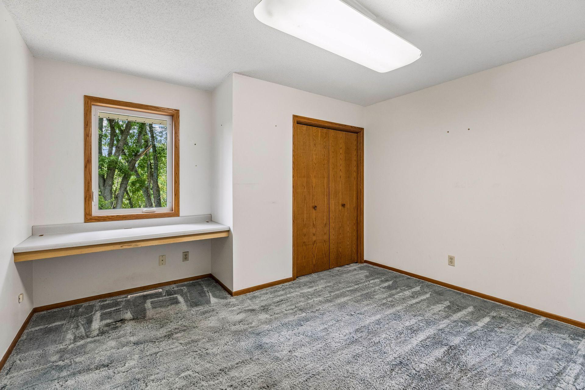 Upper level bedroom with built-in desk.