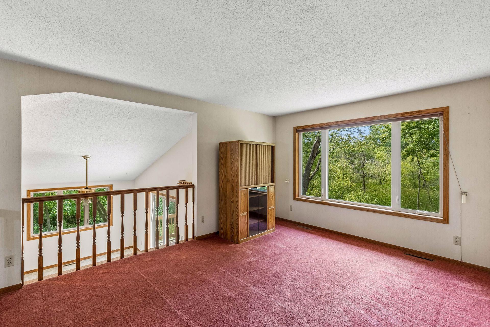 Upper level family room, loft or formal dining room with views of the backyard.