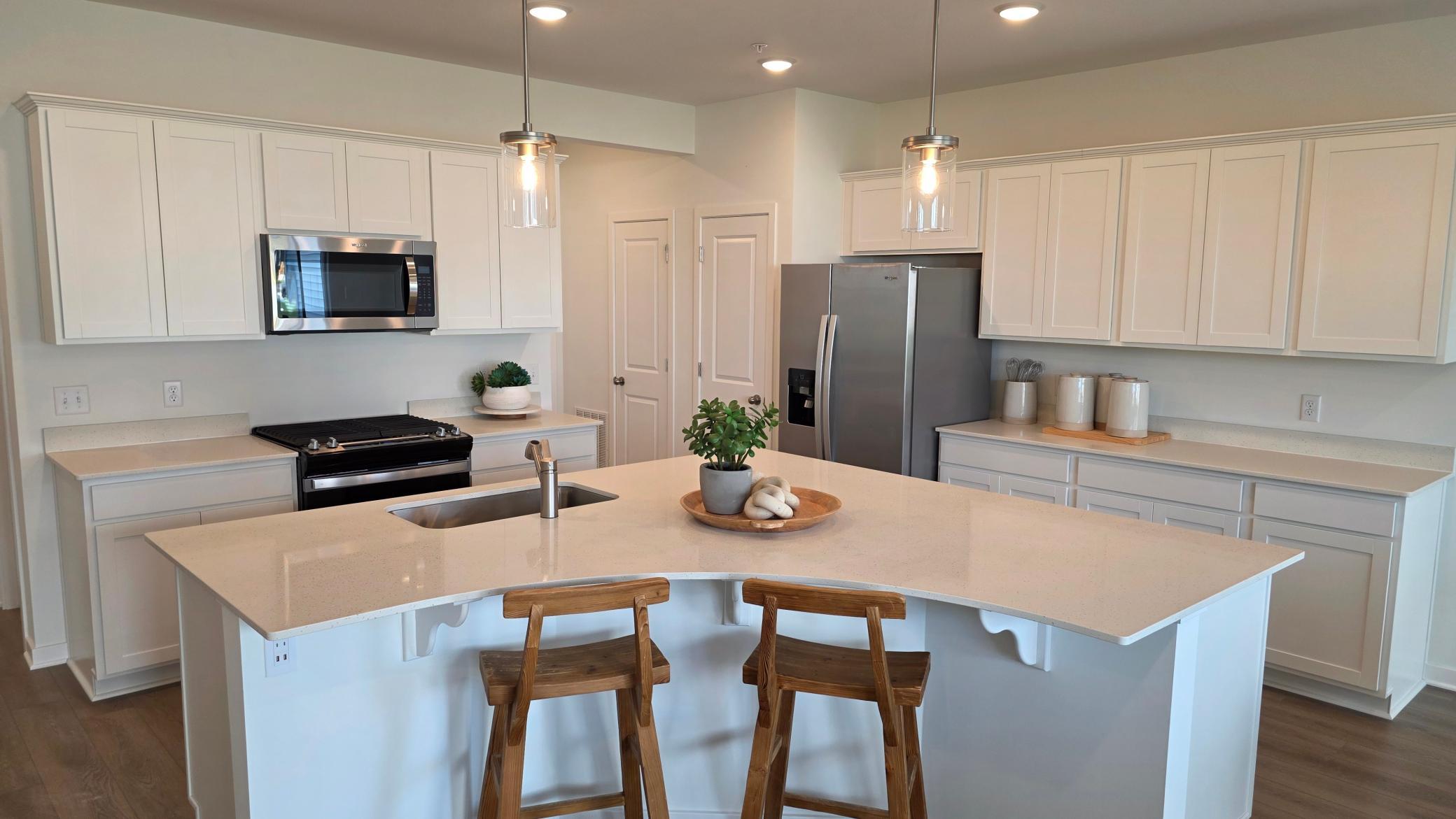 Expansive quartz island with seating (Actual home - furniture not included)