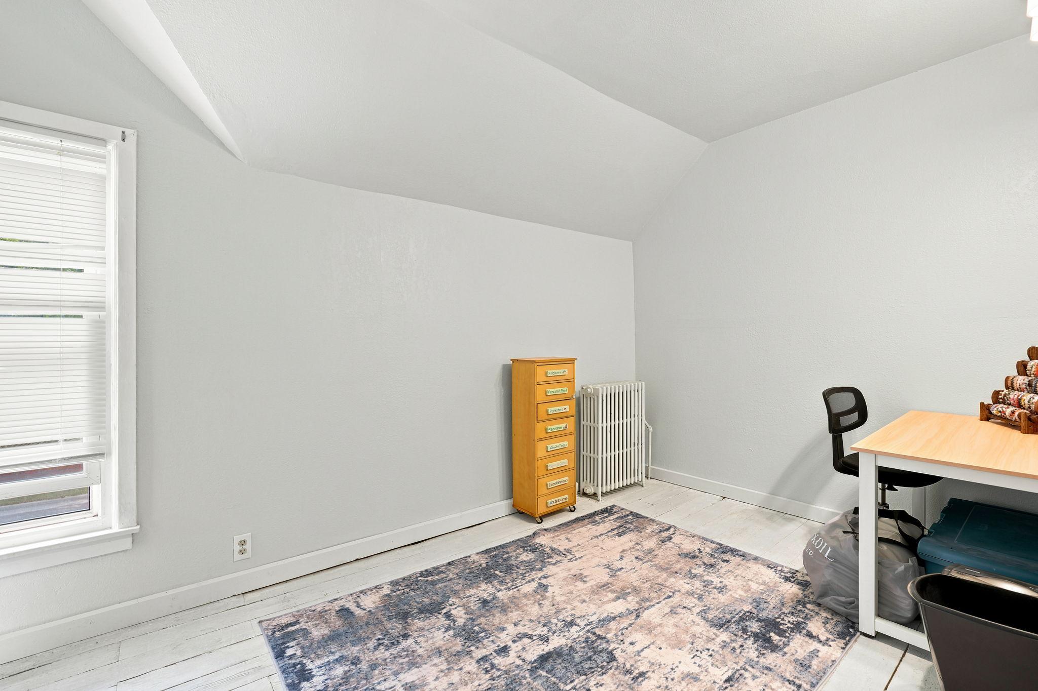 Bedroom 3 features the original plank flooring.