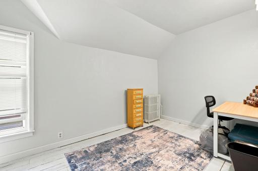 Bedroom 3 features the original plank flooring.