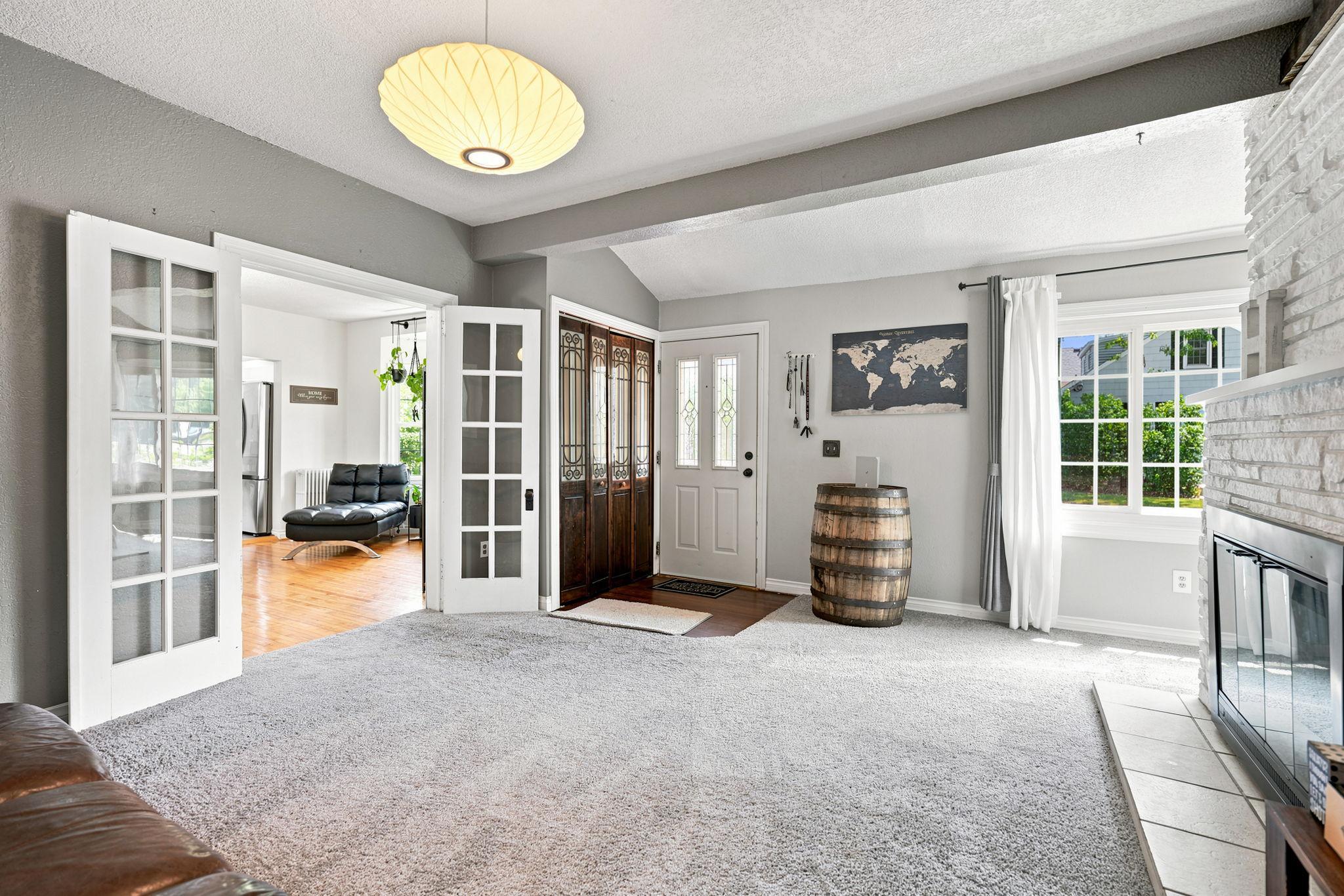 The living room is inviting and cozy. The french doors lead to dining room.