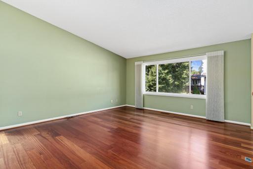 Large living room can accomodate many furniture arrangements. The vaulted ceilings give it a spacious feel.