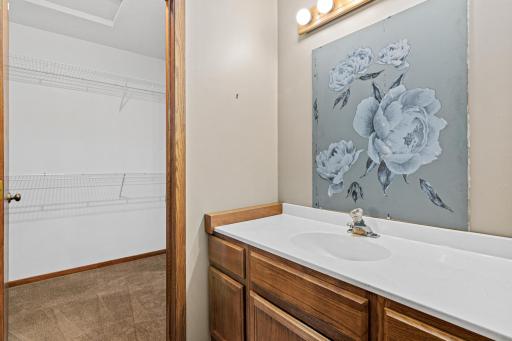 Separate counter area between the bathroom and walk-in closet gives needed get-ready space!