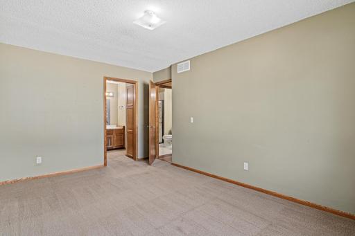 View from primary bedroom looking toward bathroom/closet area.