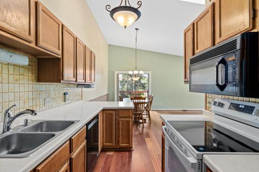 Functional layout of kitchen with new stove and newer accessory appliances.