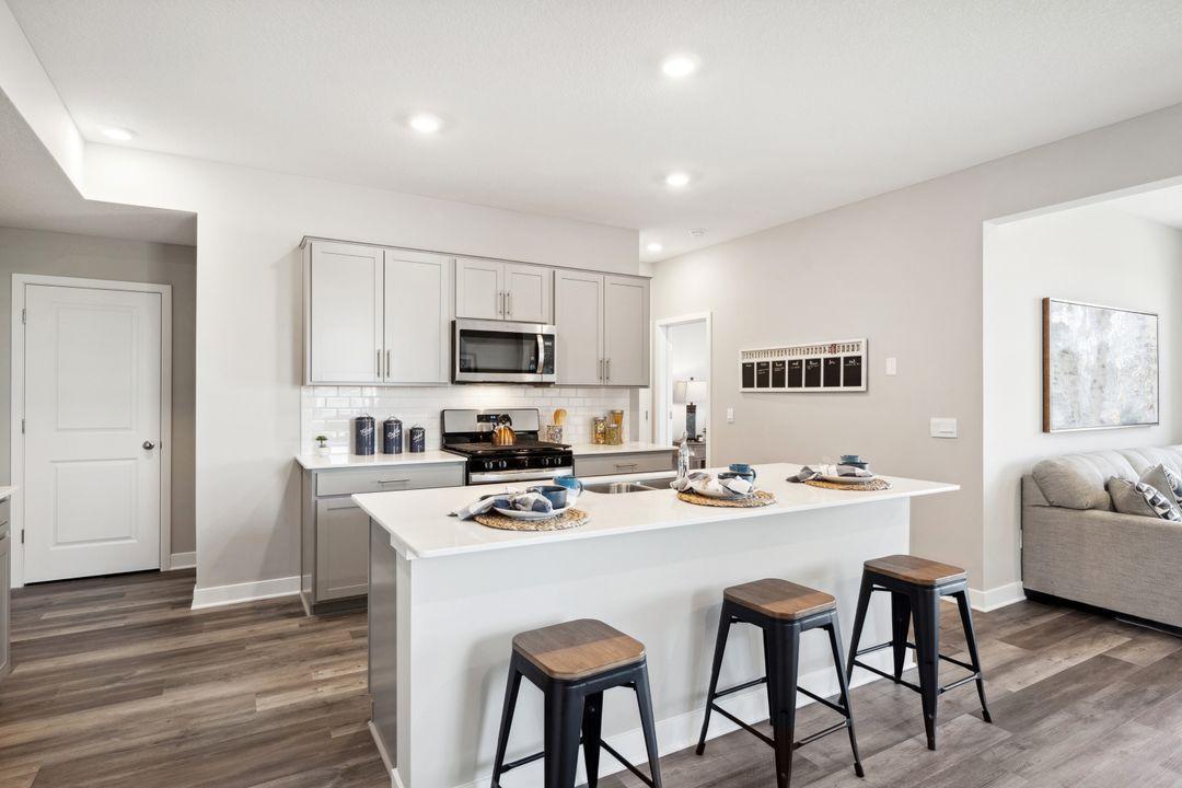 A spacious kitchen island for the family to gather around during informal meals. (Photo of model, colors are similar)