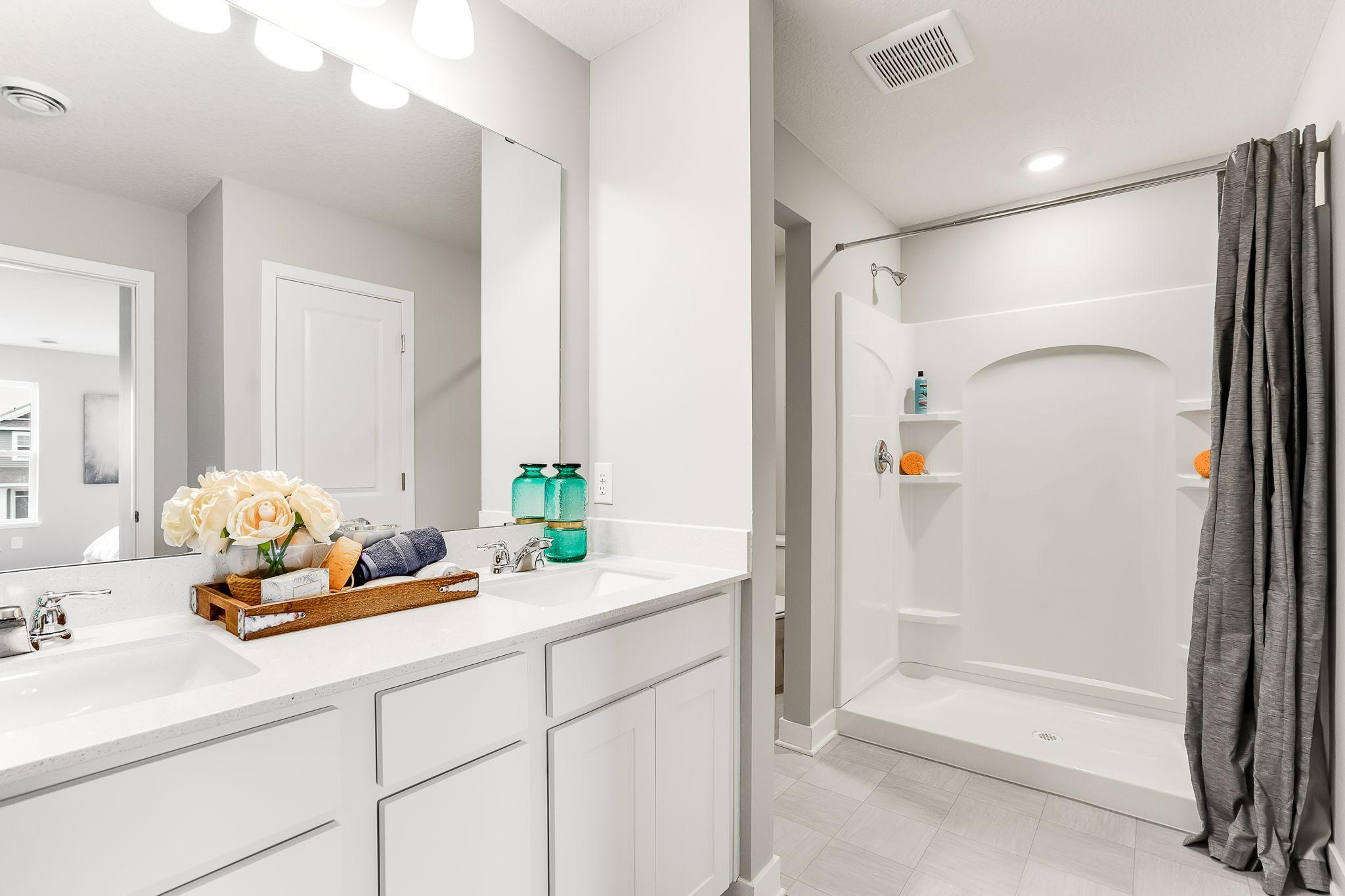 The primary bedroom has double sinks, then take refreshing shower!