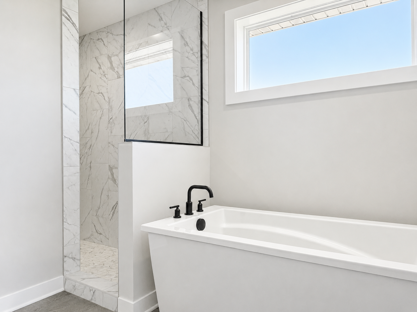 Primary ensuite freestanding tub and walk-in tile shower