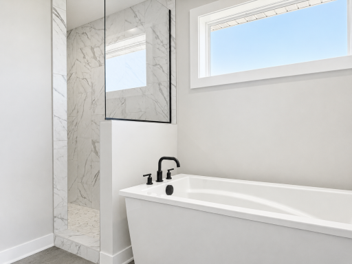 Primary ensuite freestanding tub and walk-in tile shower