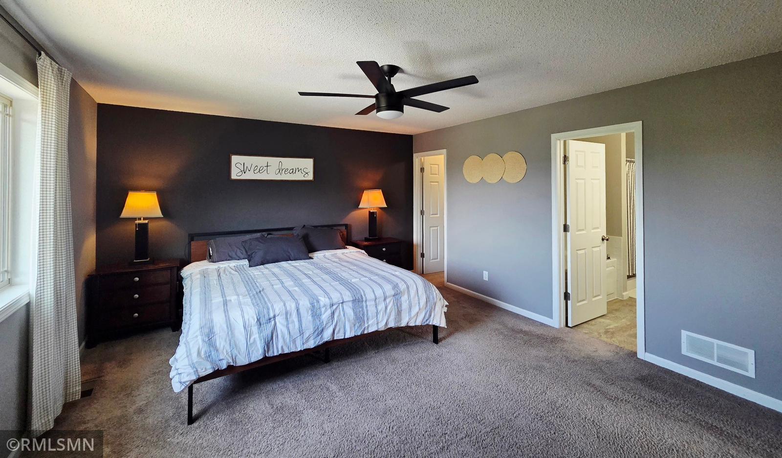 Master bedroom featuring walk-in closet and master bathroom