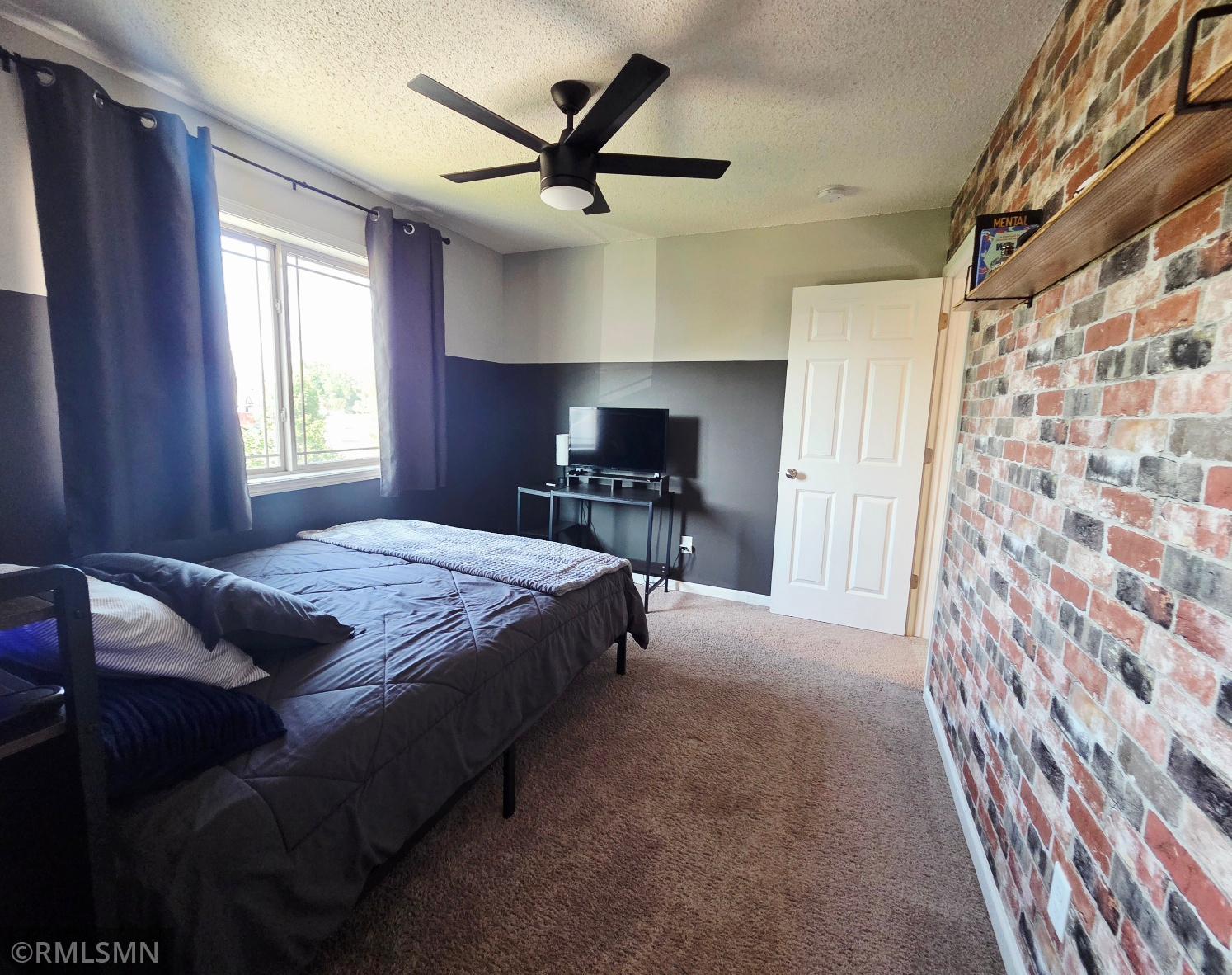 Second bedroom featuring walk-in closet